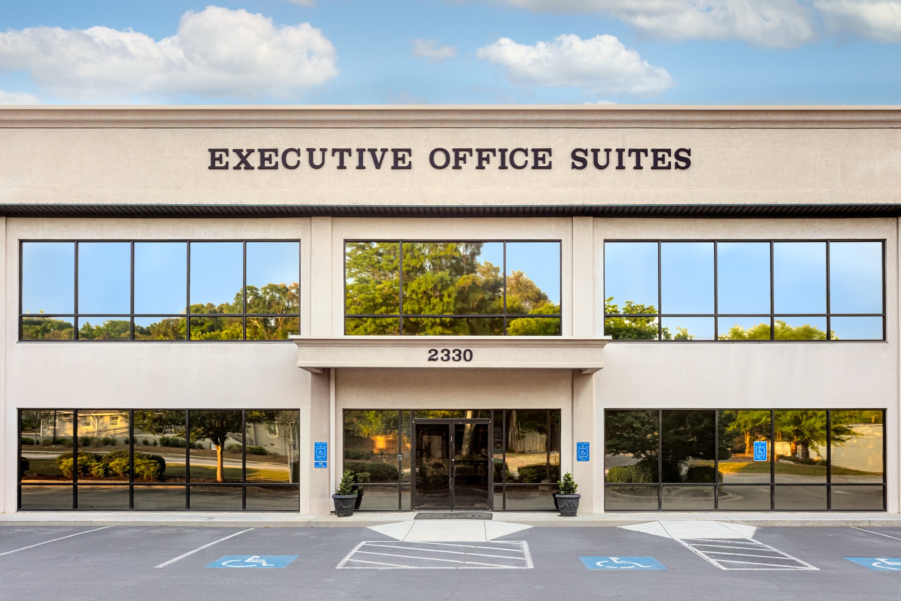 Front entrance of Scenic Office Suites with signage and glass doors