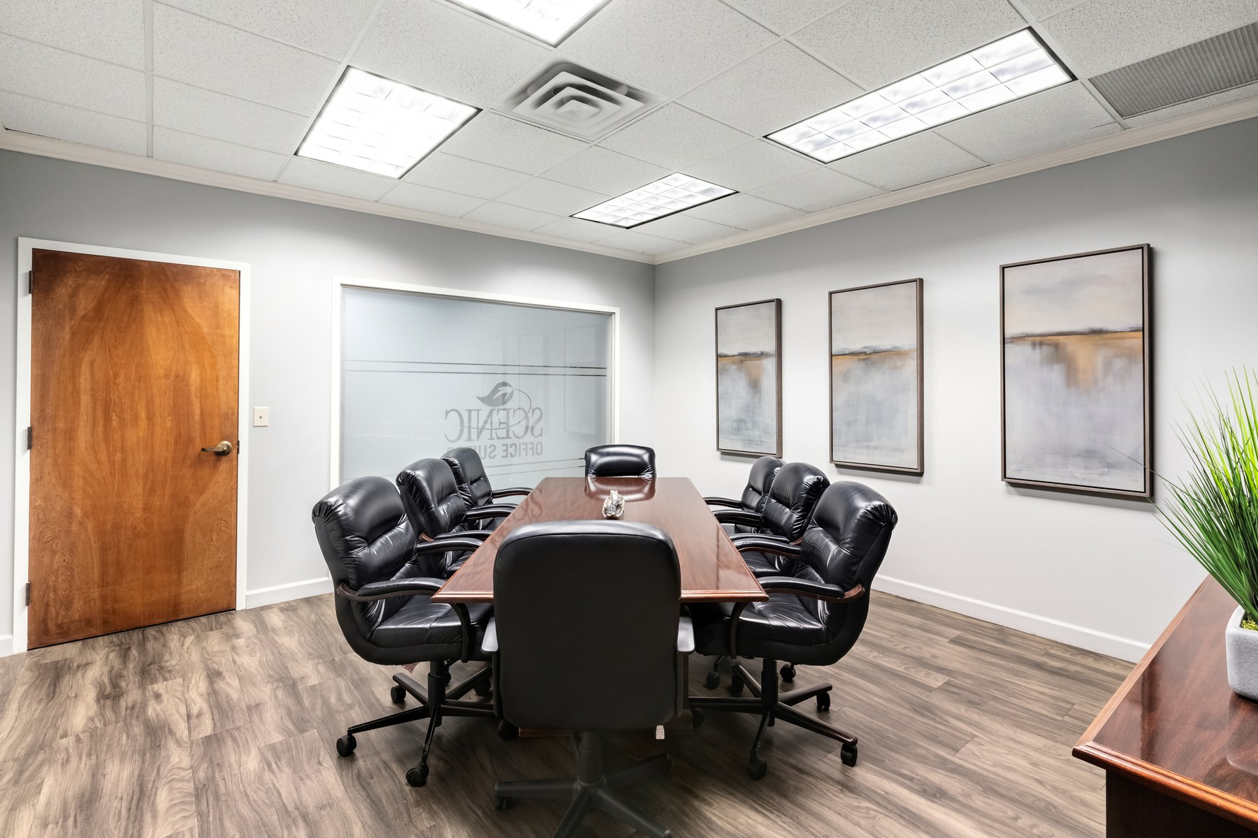 Conference room at Scenic Office Suites with an oval table and executive seating